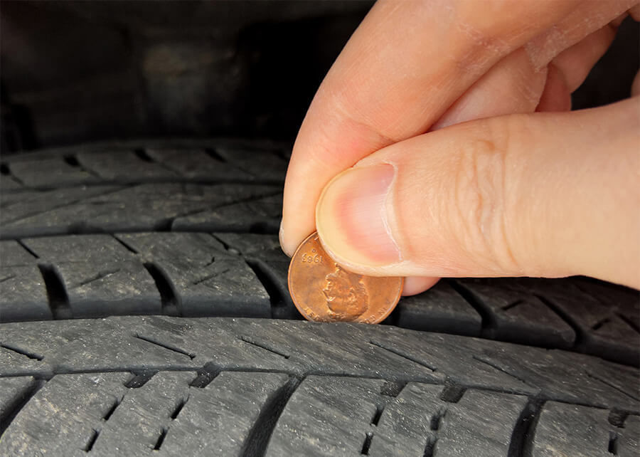 Checking tire tread depth with a penny