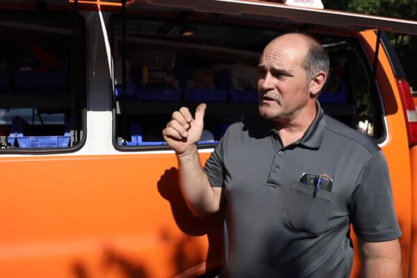 Electrician with storage bins in van